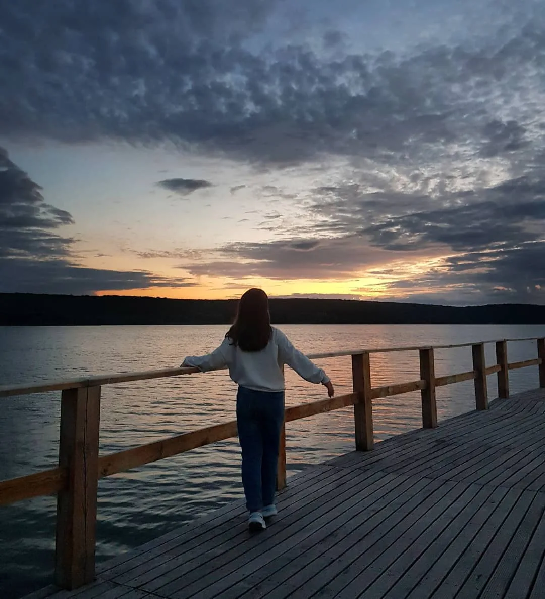 Woman on dock watching sunset - Abigail Mind Body Soul